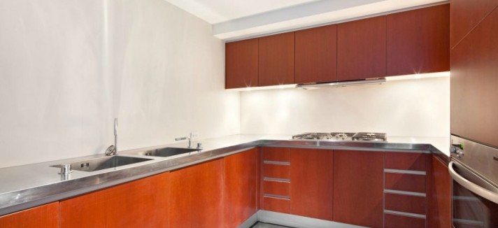 the-kitchen-features-varenna-cherry-wood-cabinets-stainless-steel-countertops-and-miele-applianc