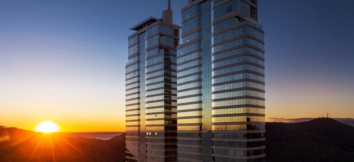 Las dos torres están revestidas con vidrio oscuro reflectante, interrumpido por bandas horizontales de aluminio que actúan como elementos de protección solar.