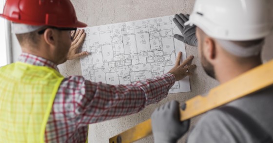 Primo piano di professionisti che esaminano un progetto edile 