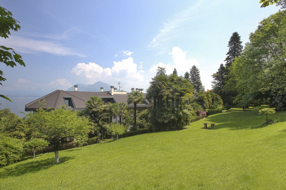 The property is surrounded by a large garden and enjoys views of the lake