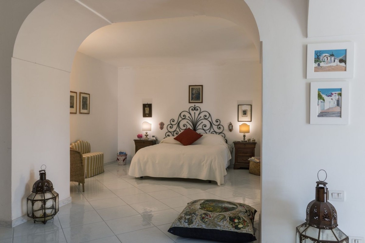 One of the bedrooms with white decor