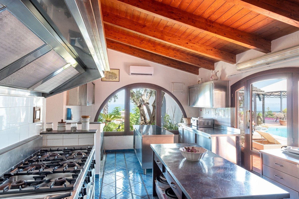 The kitchen is spacious and has terrace access