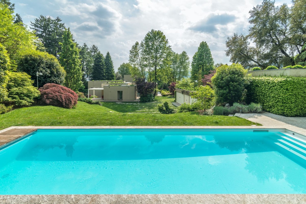 The villa is surrounded by a beautiful garden and pool