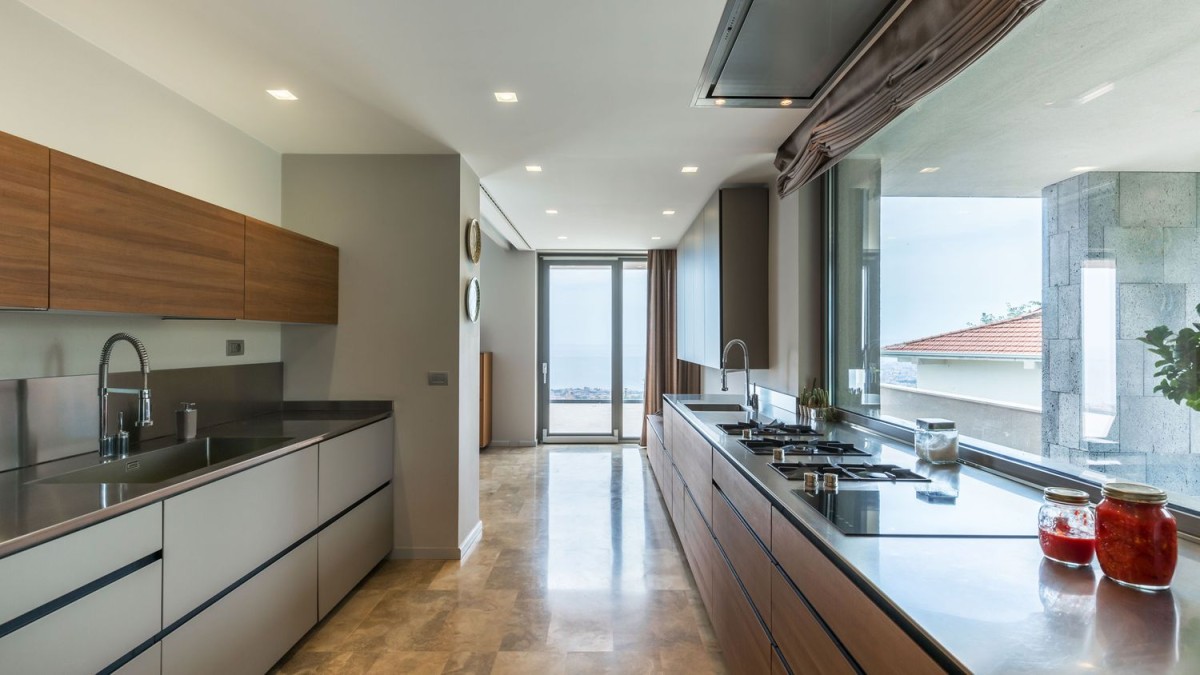 The kitchen is modern, spacious and enjoys some the best views in the villa