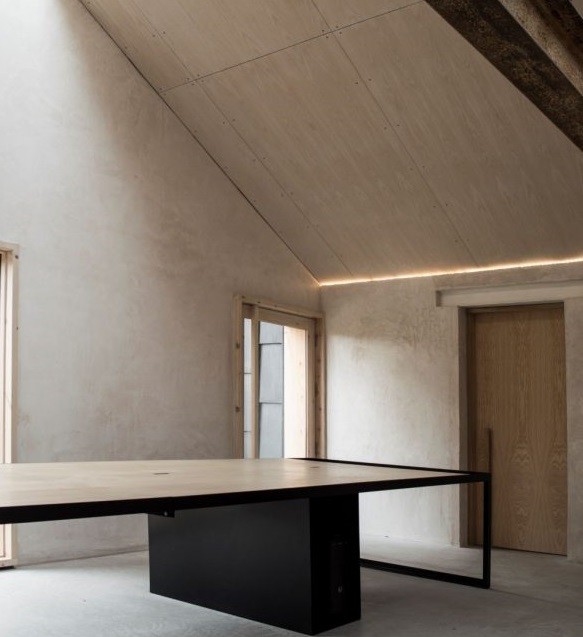 Soffitti inclinati e grandi tavoli da lavoro