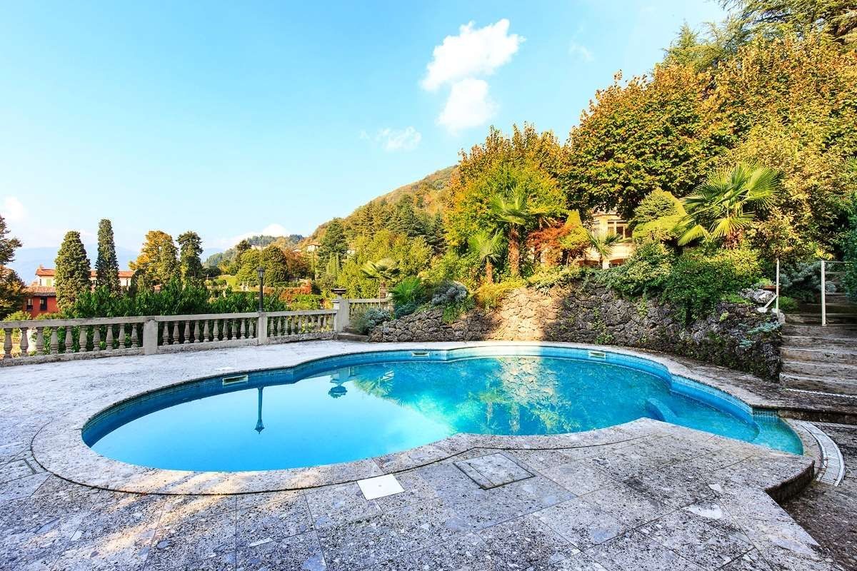 The property has a stunning outdoor pool surrounded by nature