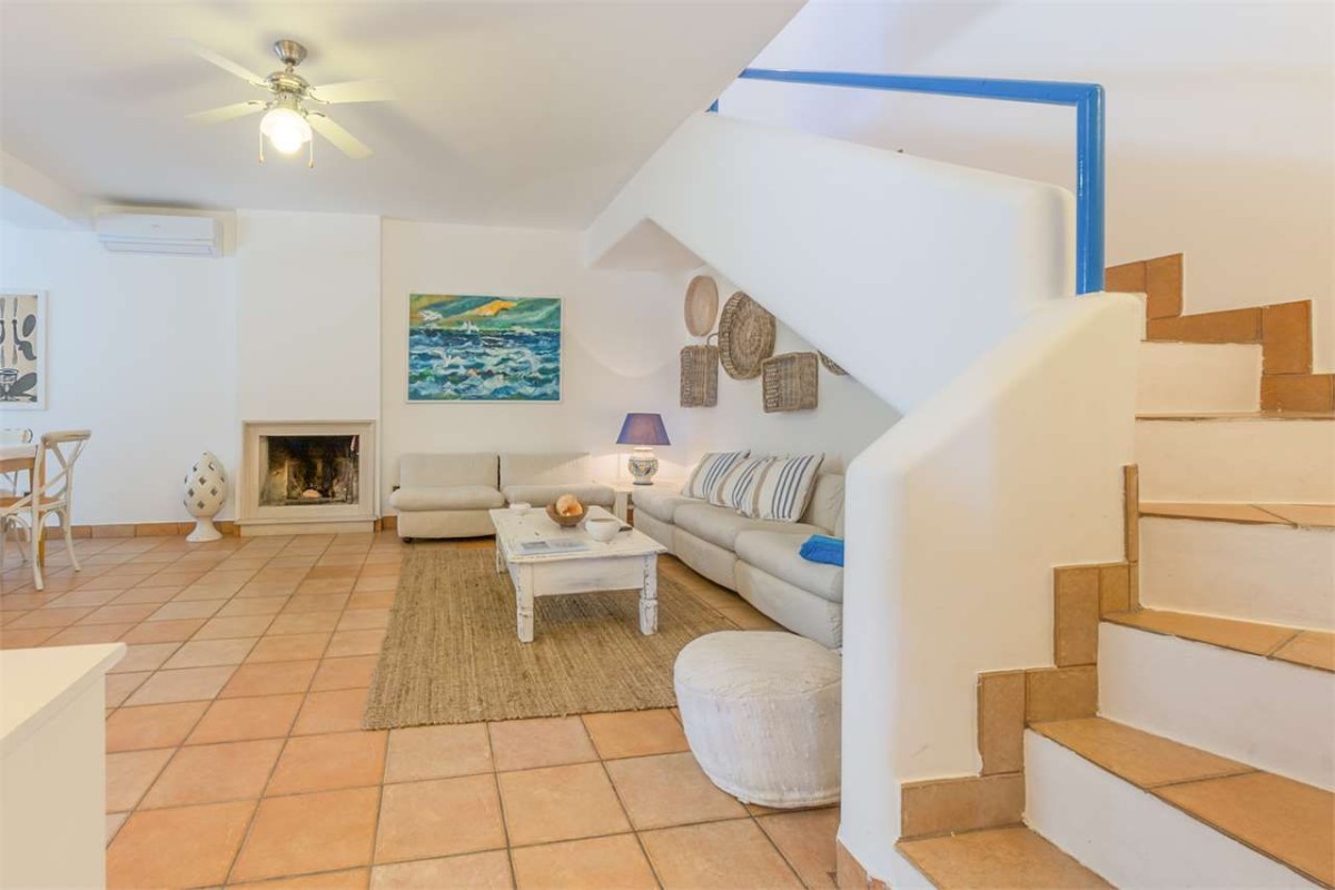 The main living room is open and has crisp blue and white decor