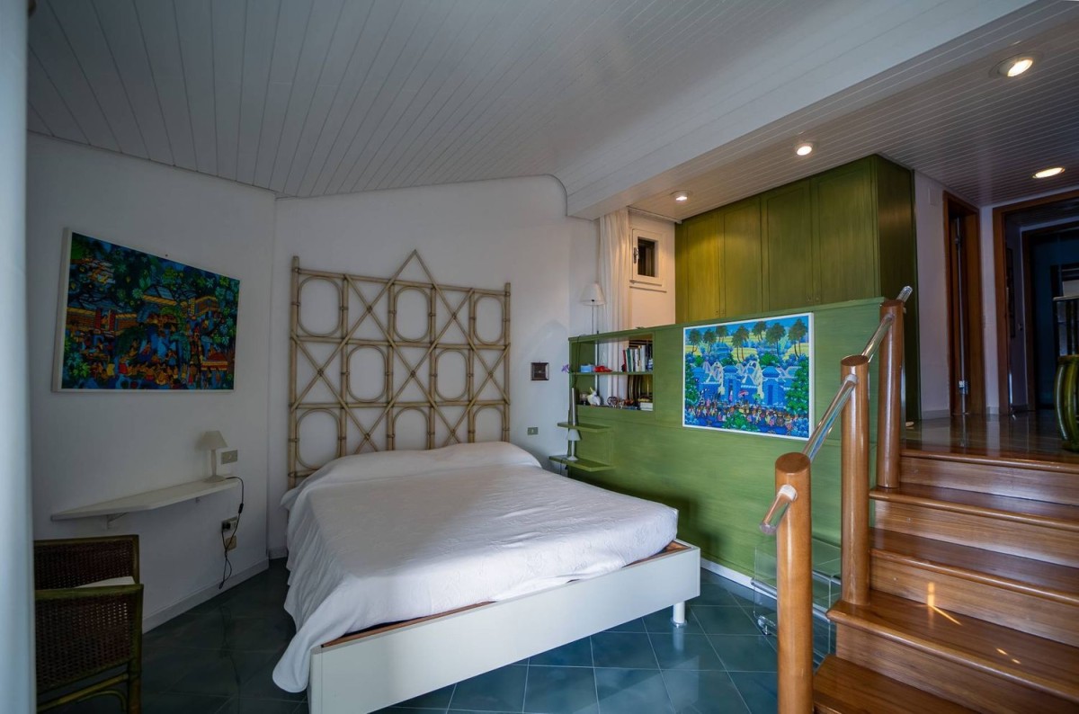 The master bedroom is tucked away in a private corner of the property