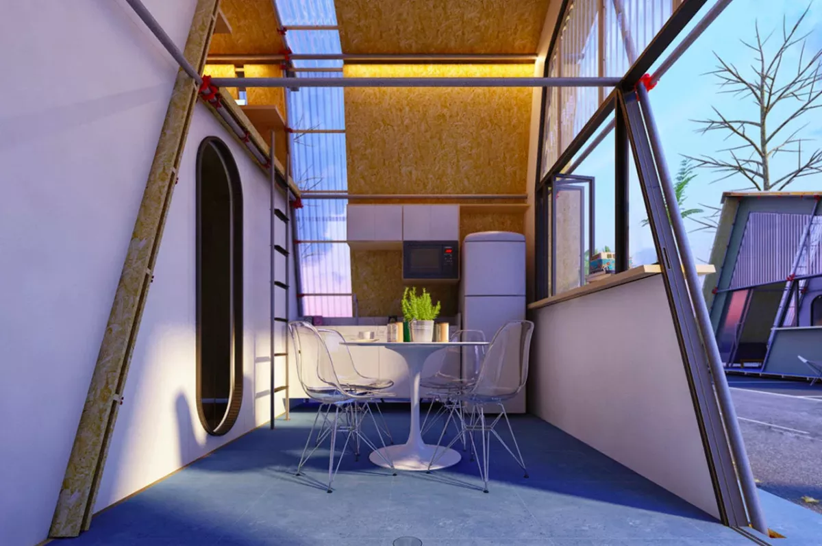 Salón con cocina abierta y una mesa con sillas