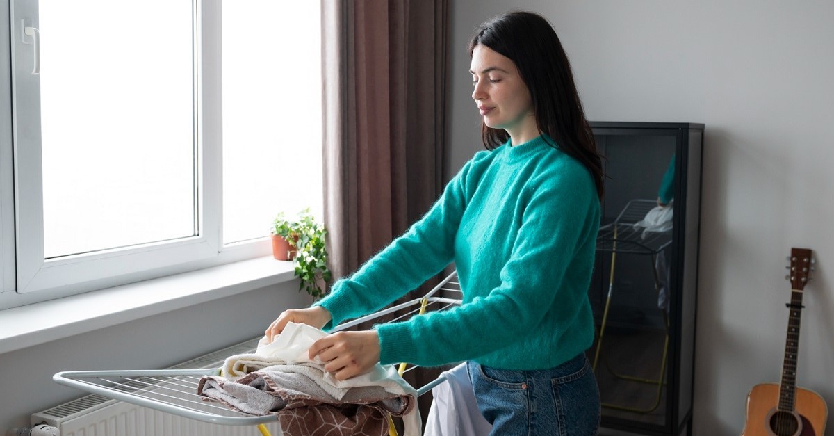 Donna che ritira il bucato da uno stendino