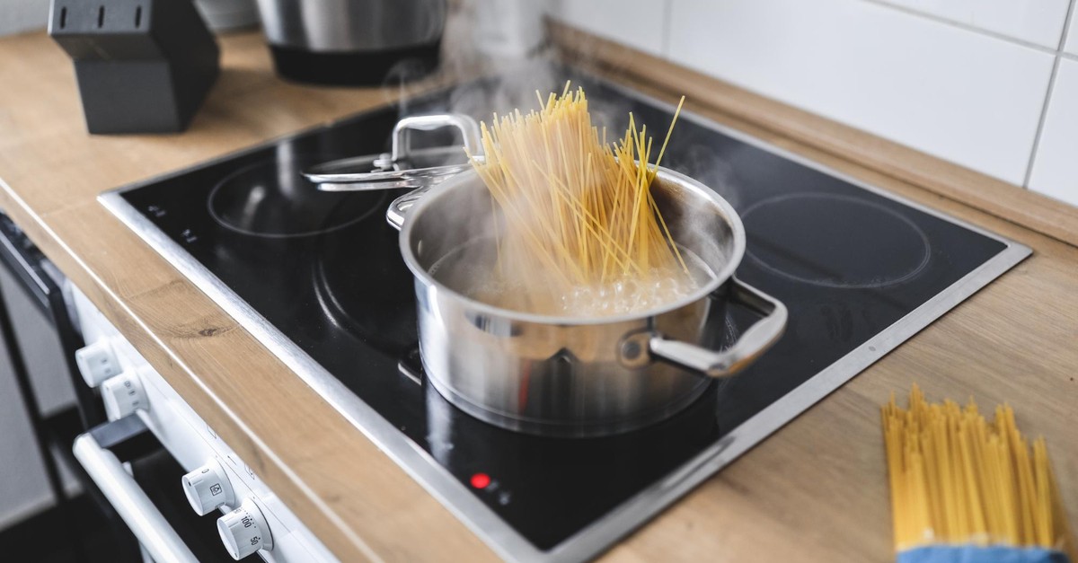 Pentola con spaghetti su piano a induzione