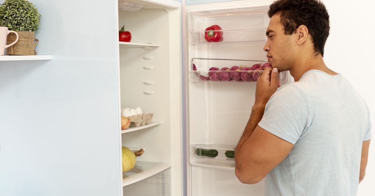 uomo davanti a frigo aperto 
