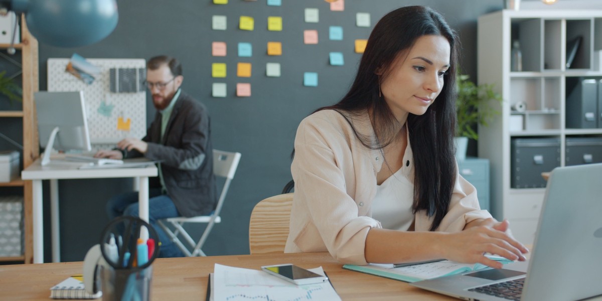 Professionisti che lavorano in un ufficio con computer portatili e arredi variegati