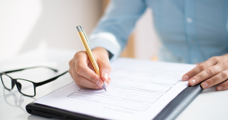 primo piano donna che firma fideiussione bancaria