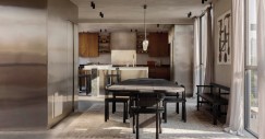 Pareti in stucco texturizzato, mobili in legno di noce e acciaio inossidabile