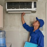 Un tecnico al lavoro su un condizionatore