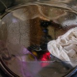 Lavatrice con acqua e panni ancora nel cestello