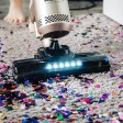 Aspirapolvere su un tappeto pieno di coriandoli